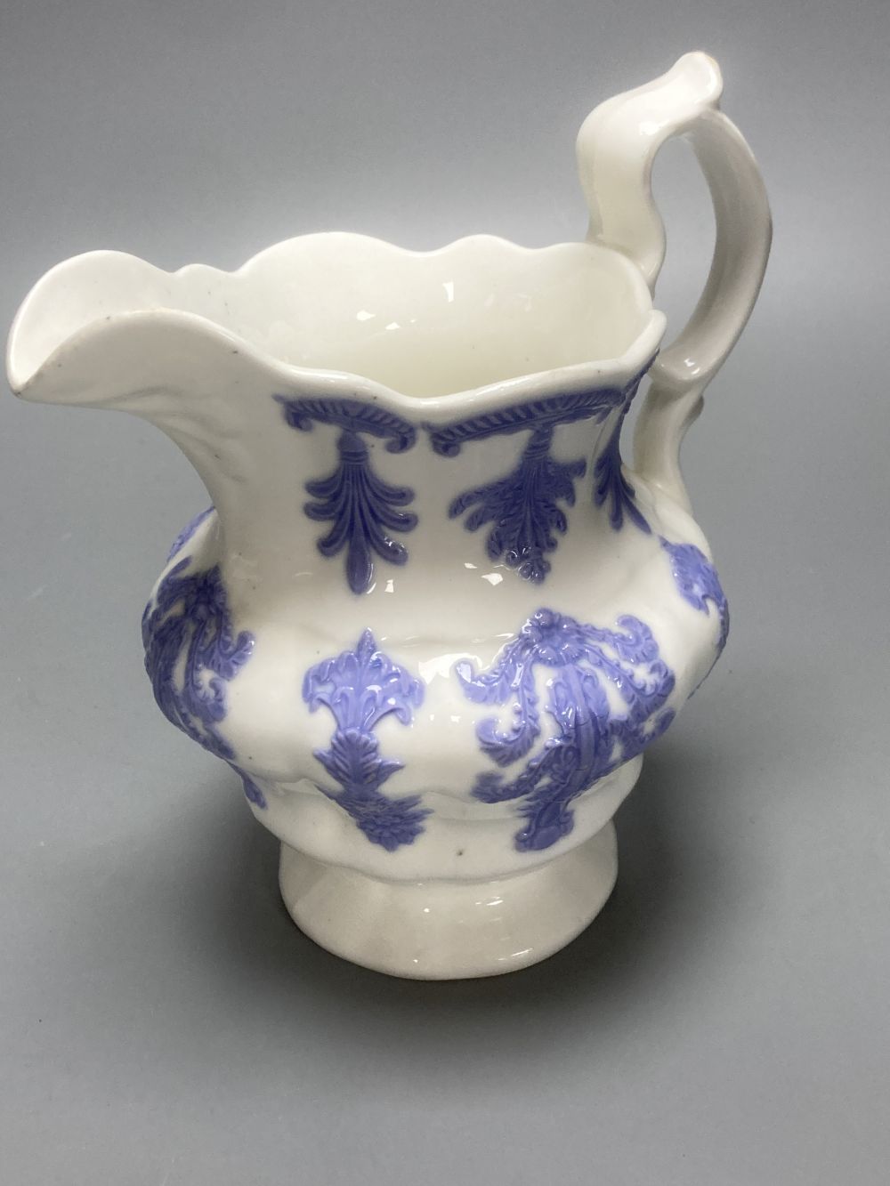 Four early 19th century Staffordshire jugs, each with lilac coloured floral applied panels, one dated 1826, tallest 22cm